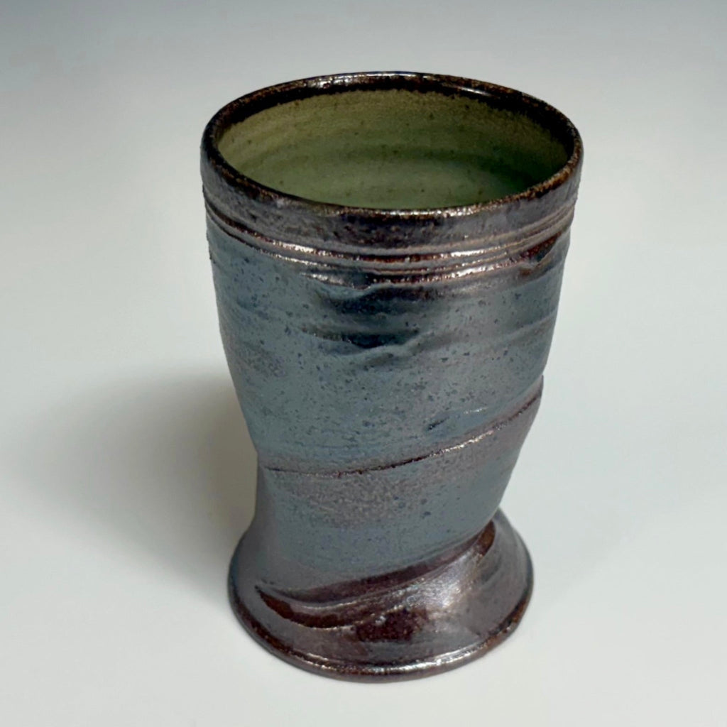 Handcrafted wood-fired pottery cup with green-dark brown exterior and celadon green interior, made in Danbury, NC.