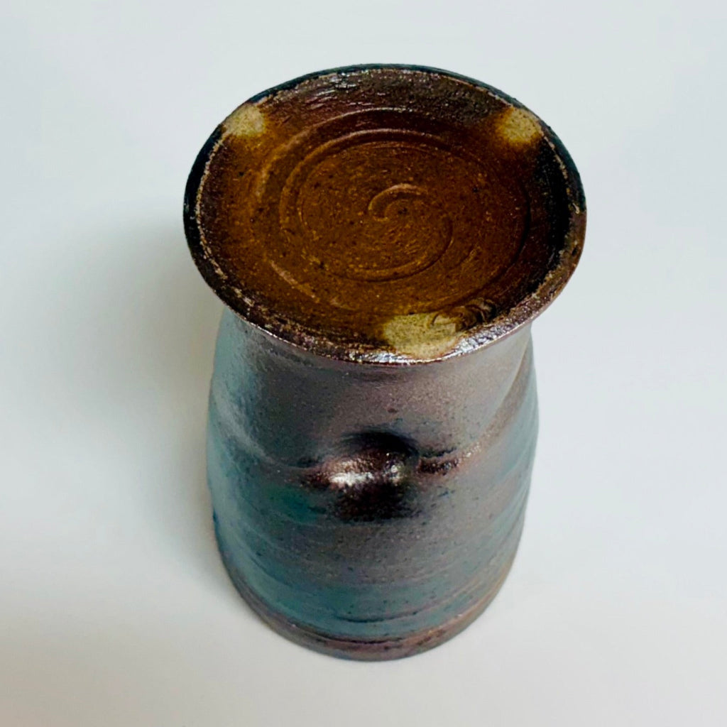 Bottom view of spiral and green-dark brown exterior and celadon green interior, made in Danbury, NC.