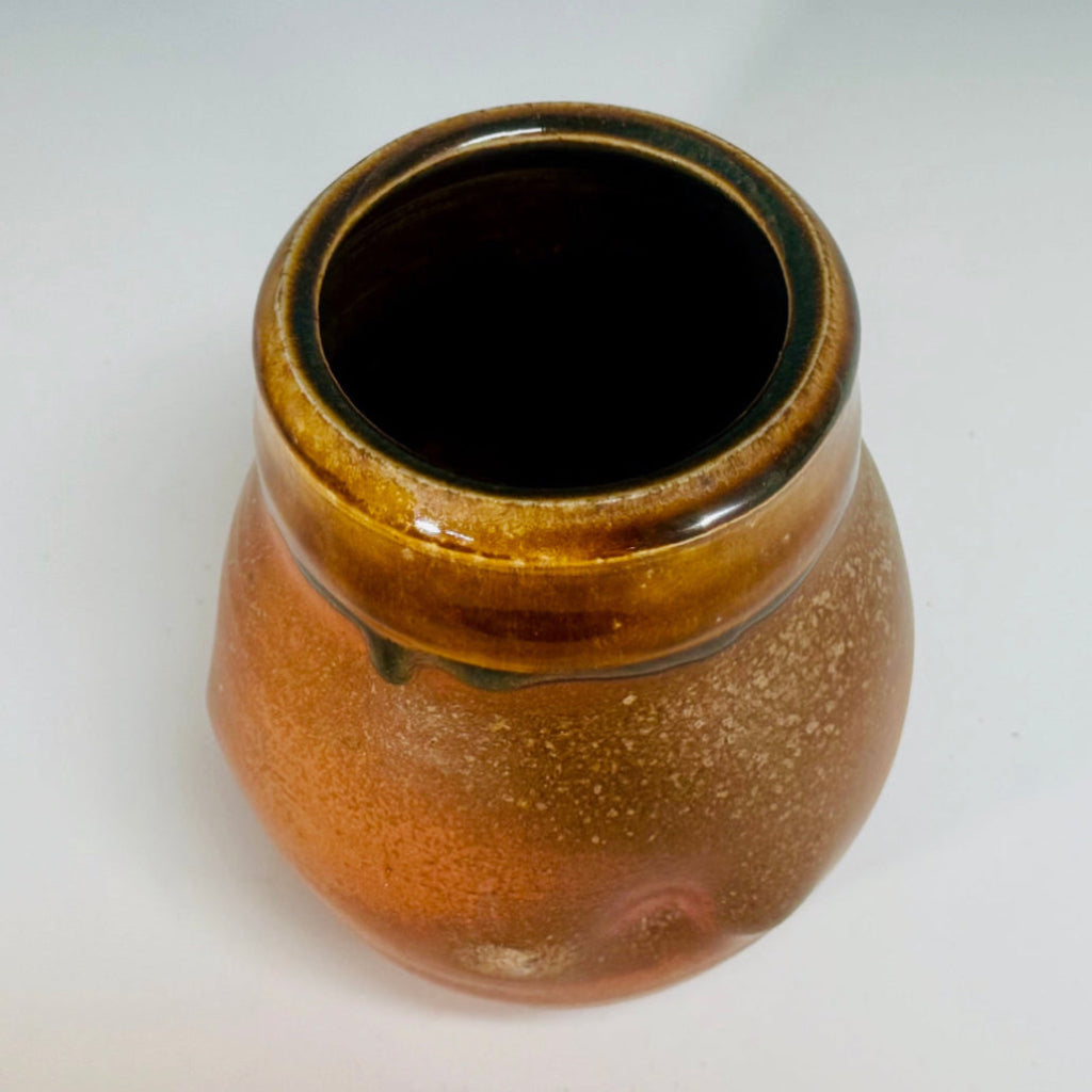 Rustic small vase with amber glaze on speckled terracotta clay, handmade and wood-fired in Danbury, NC.