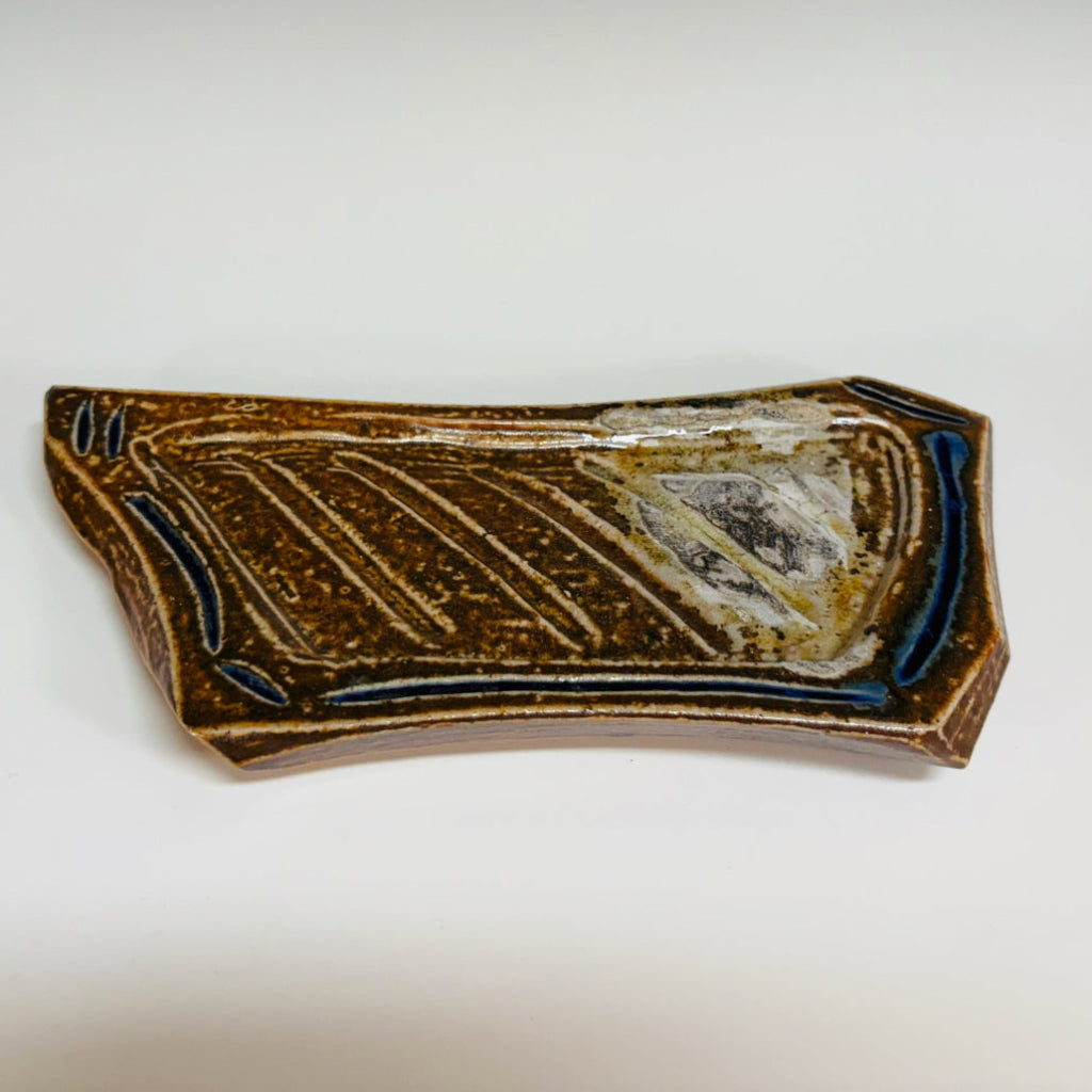 Handcrafted elongated soap dish with carved pattern and vibrant blue accents on brown stoneware, wood-fired in Danbury, NC.