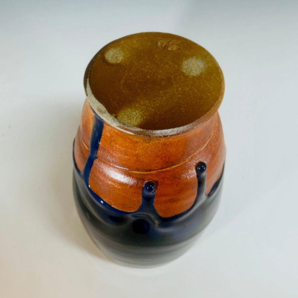 Bottom of handcrafted medium vase with cascading blue glaze over terracotta clay body, wood-fired in Danbury, NC.