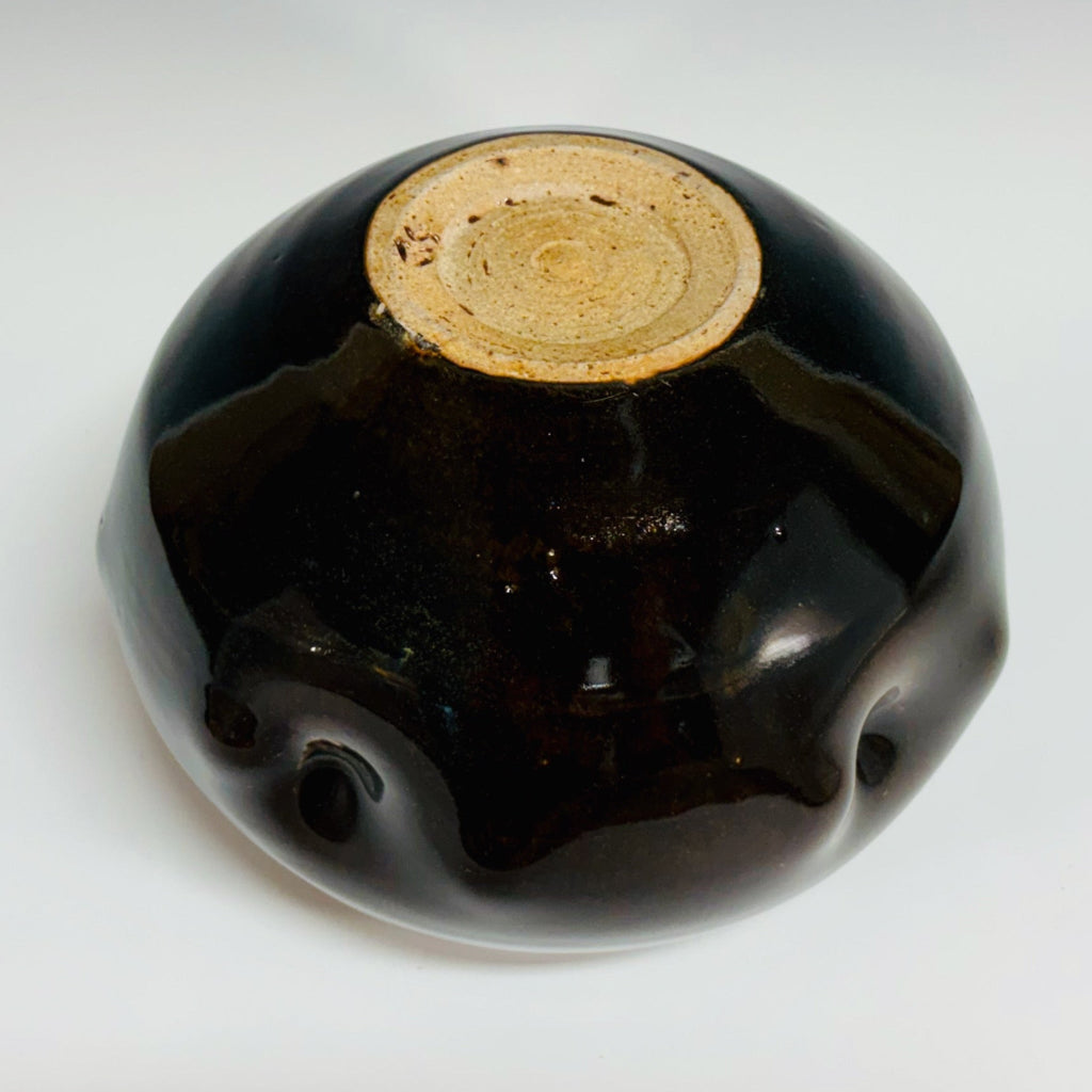 Bottom view: Round chestnut glazed vase with tactile dimpled surface, handmade and wood-fired in Danbury, NC.