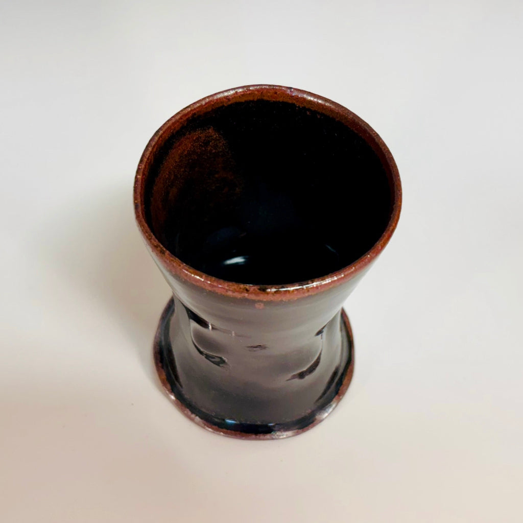 A stunning cup with Tenmoku glaze that creates a rich, shiny dark brown finish.