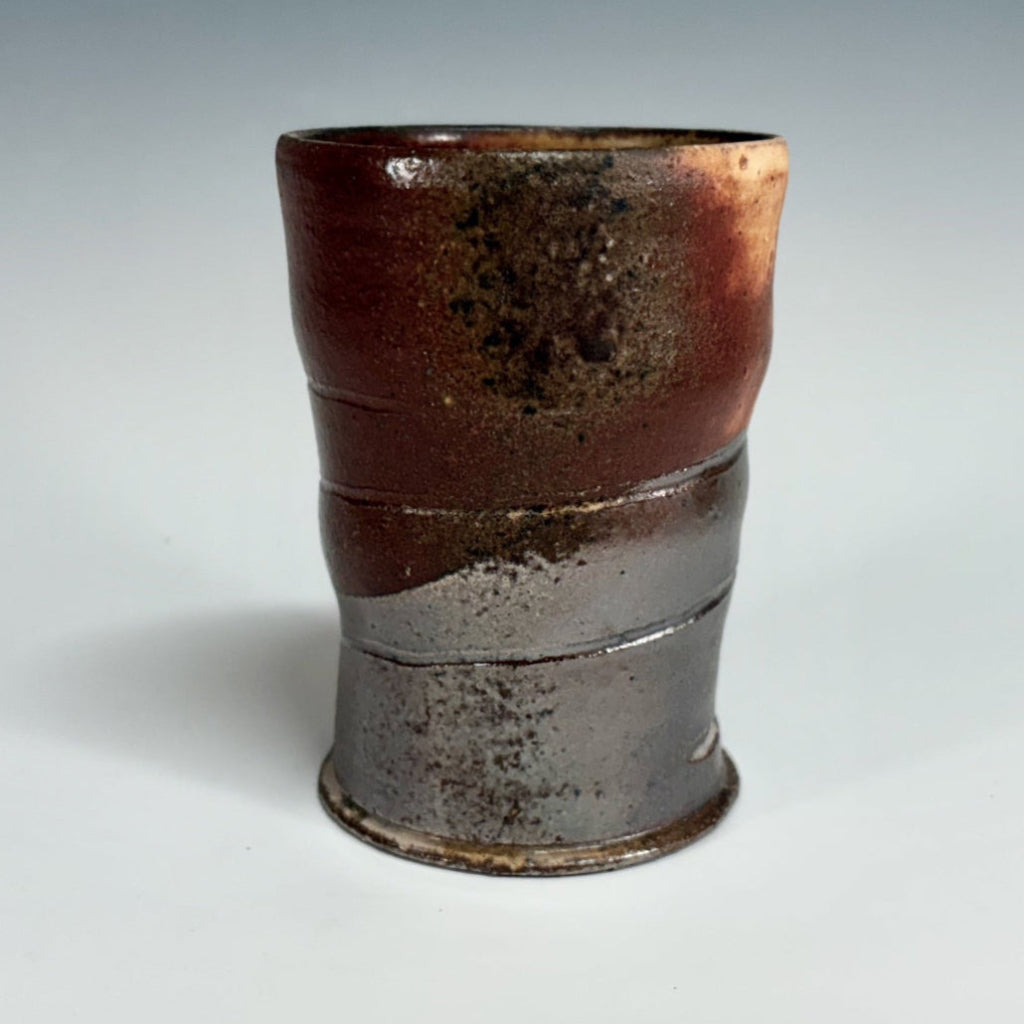 Hand-thrown copper-banded tenmoku cup with distinctive ridges, wood-fired in historic NC kiln.