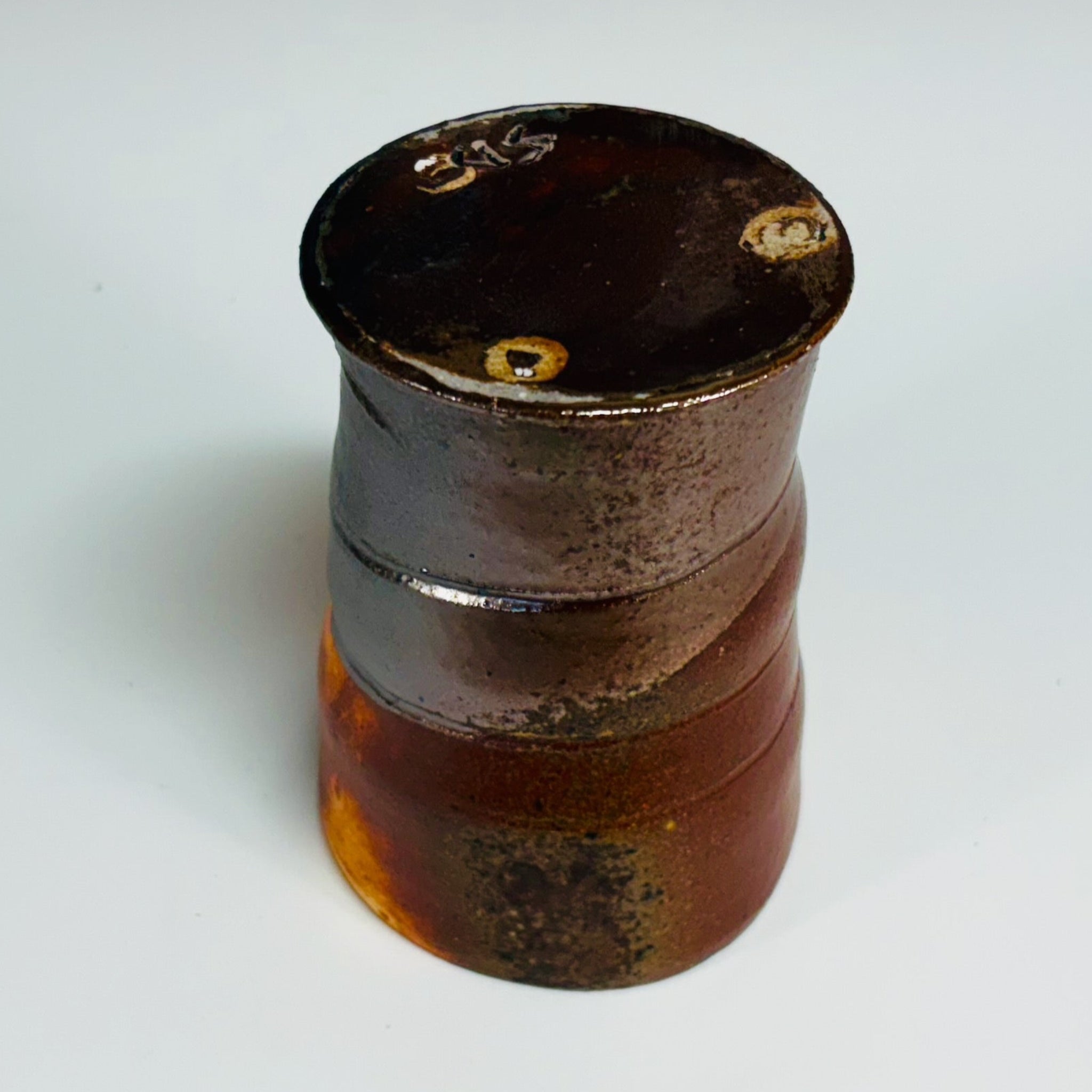 Hand-thrown copper-banded tenmoku cup with distinctive ridges, wood-fired in historic NC kiln.