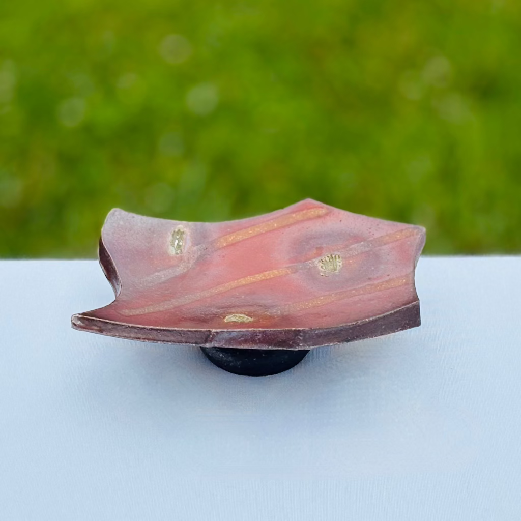 Curved wood-fired ceramic soap dish with flashing and fly ash glazes and natural flame pattern effects