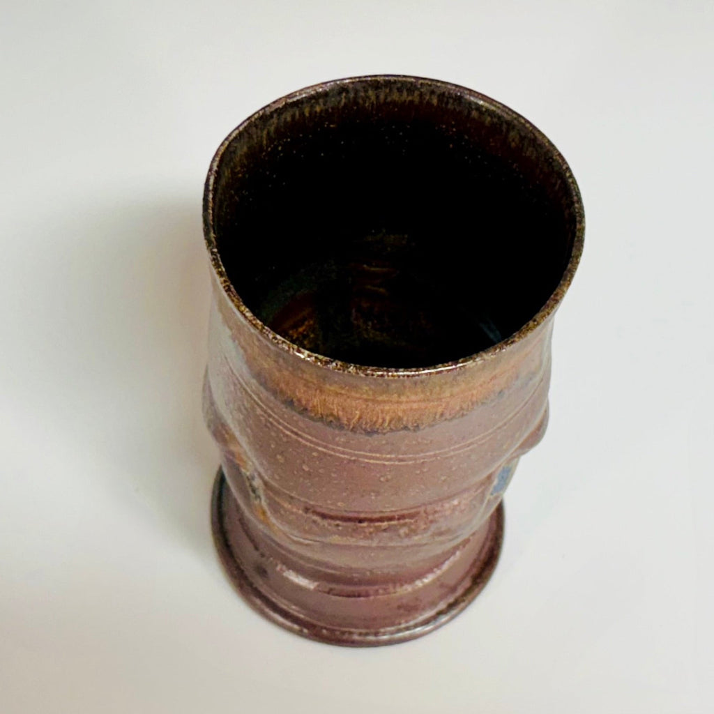 Top view: Hand-thrown ceramic tumbler with amber rim gradient and chocolate brown body and brown interior.