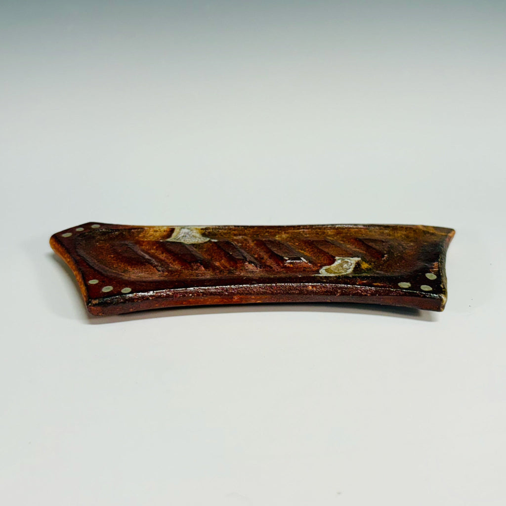 Handmade rectangular soap dish with ridged design and decorative dots in rustic terracotta tones, wood-fired in North Carolina