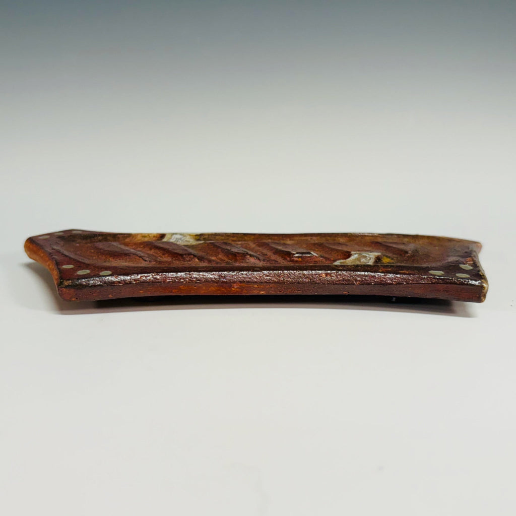 Handmade rectangular soap dish with ridged design and decorative dots in rustic terracotta tones, wood-fired in North Carolina.
