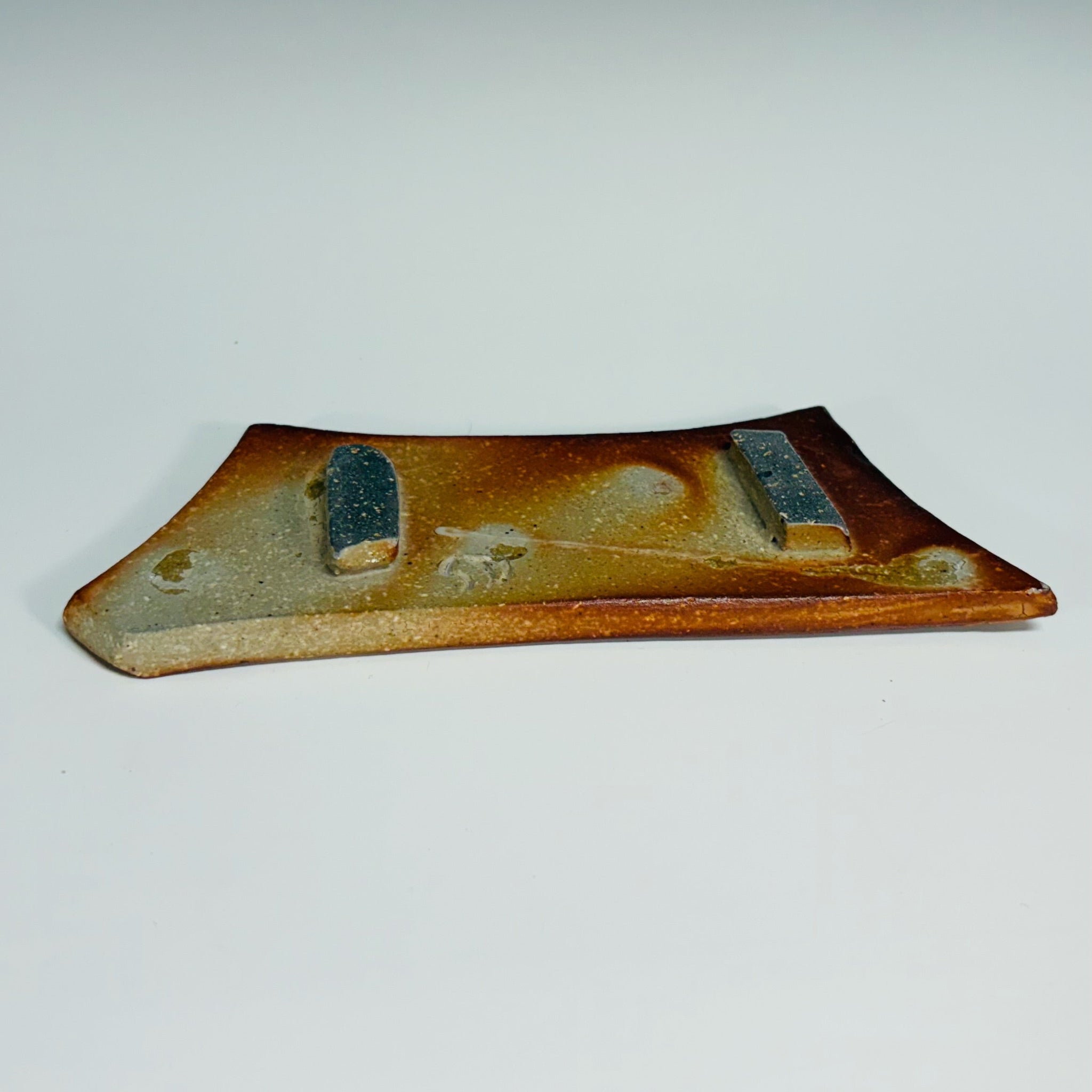 Handmade rectangular soap dish with ridged design and decorative dots in rustic terracotta tones, wood-fired in North Carolina