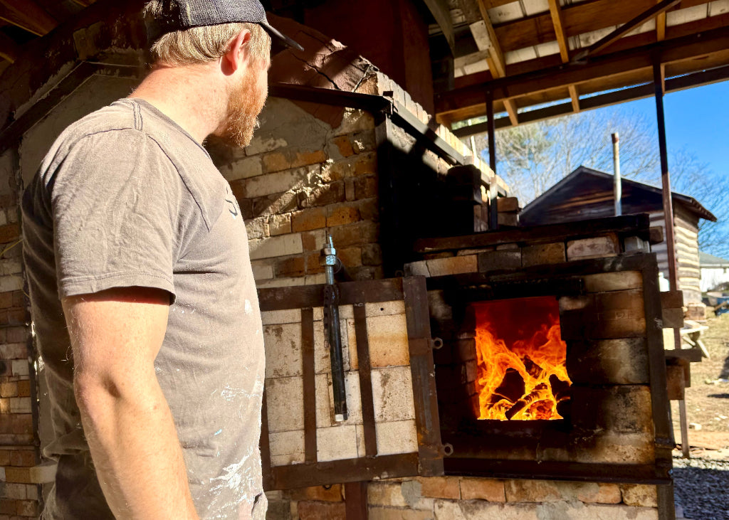 Sam Dougherty's wood-fired pottery kiln firing with a view of the flames