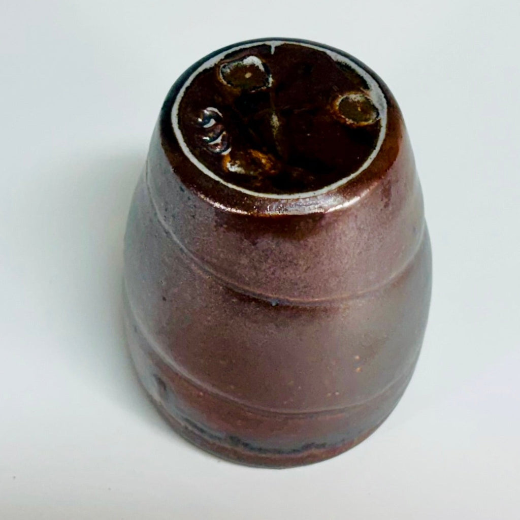 Bottom View Handcrafted wood-fired ceramic tumbler with mauve-brown body.