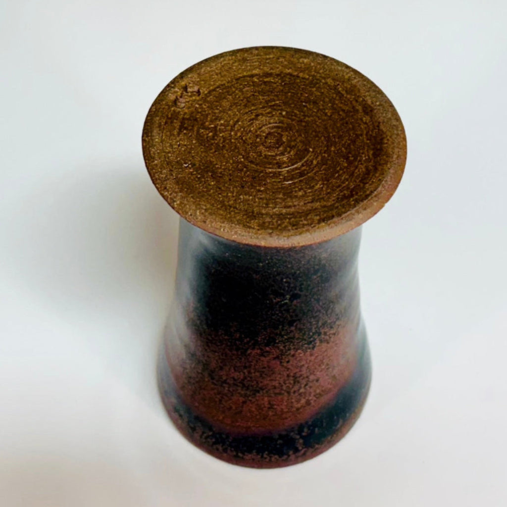 Bottom view: Handcrafted wood-fired cup with red/pink speckles and flared rim and a reddish/pink/brown interior.