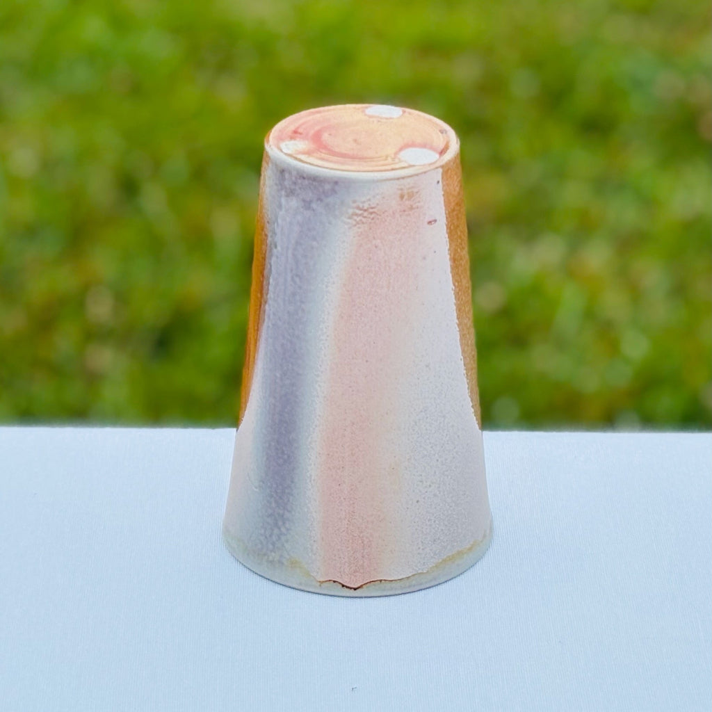 Handmade wood-fired porcelain cup with an unglazed bottom and three bottom wadding marks