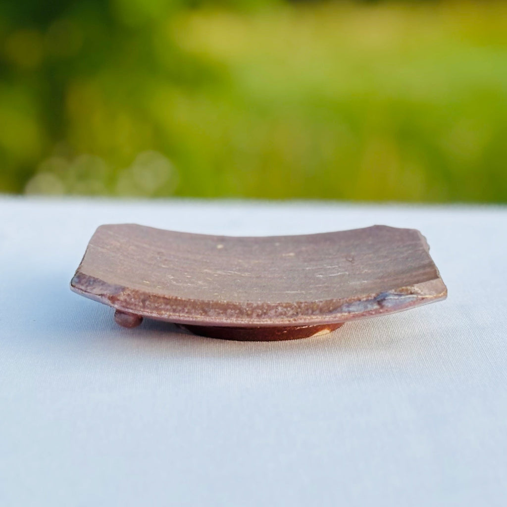 Pottery soap dish displaying rustic edge and functional design and traditional wood-firing craftsmanship techniques