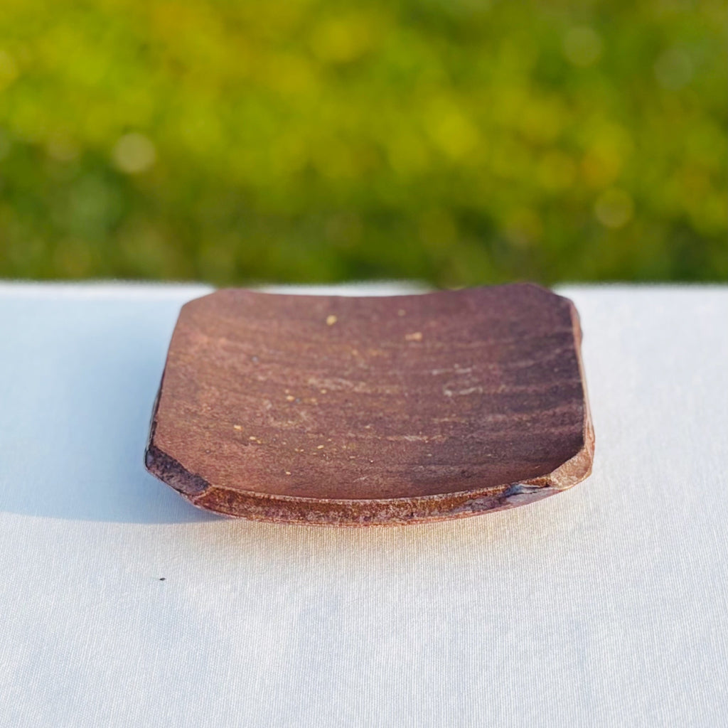 square wood-fired ceramic soap dish featuring warm medium browns and flecks of beige with natural pottery patterns