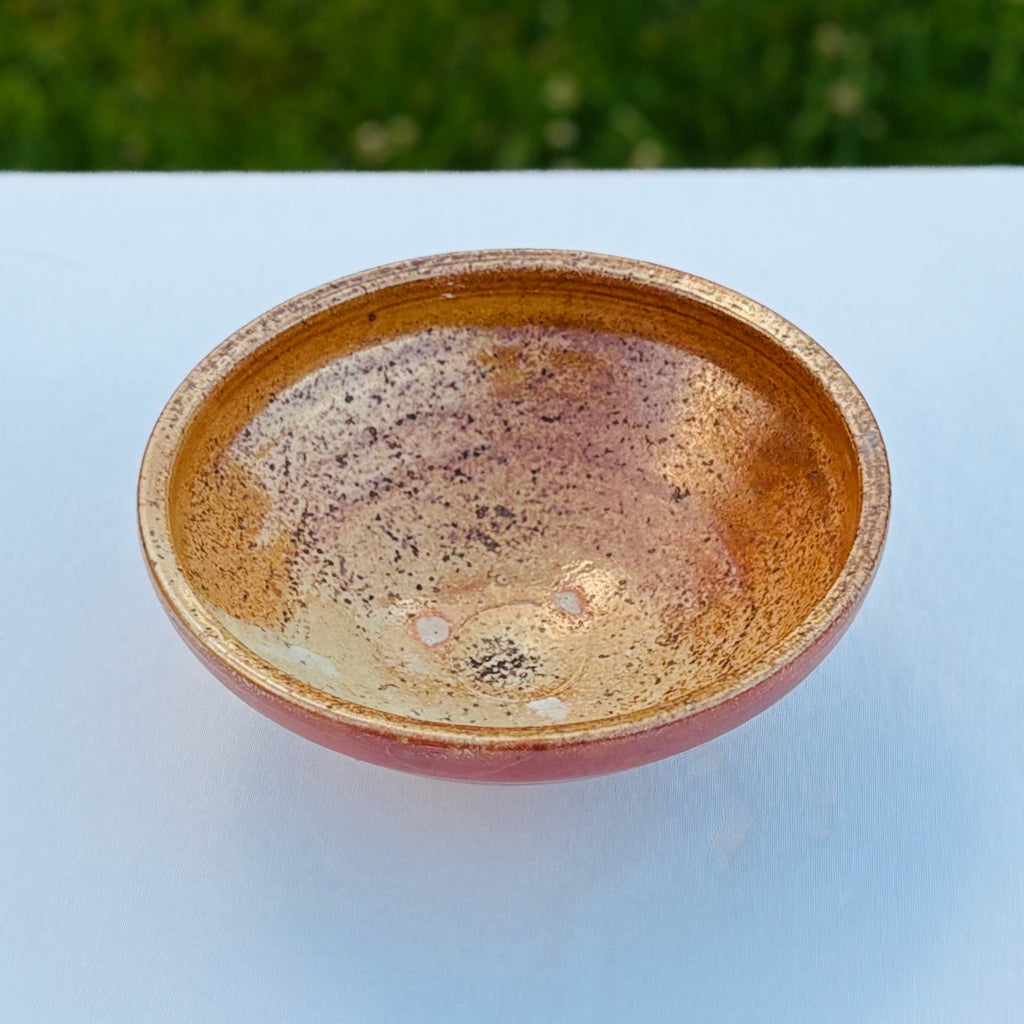 Interior view of authentic shino glazed bowl with glossy speckled amber finish