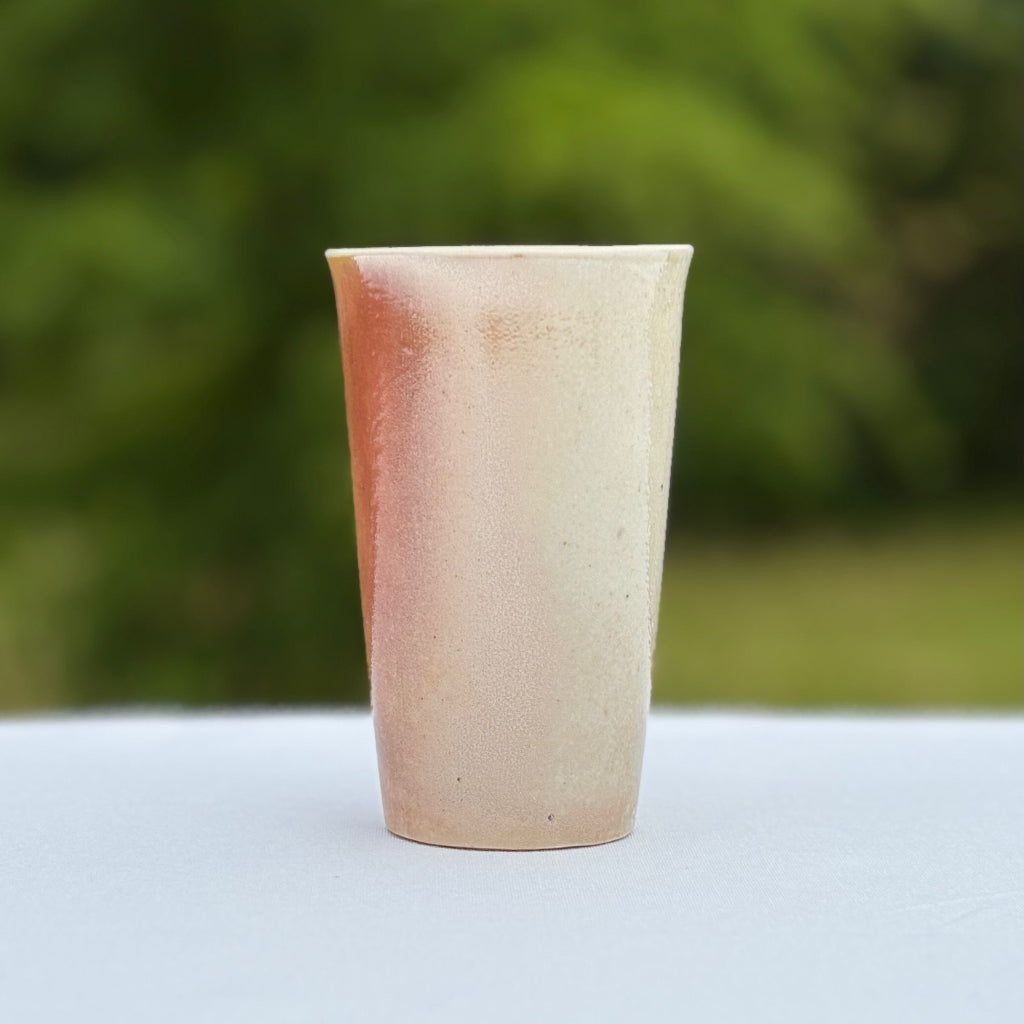 Handmade in Danbury, NC wood-fired porcelain cup by Sam Dougherty with pink/white gradient finish