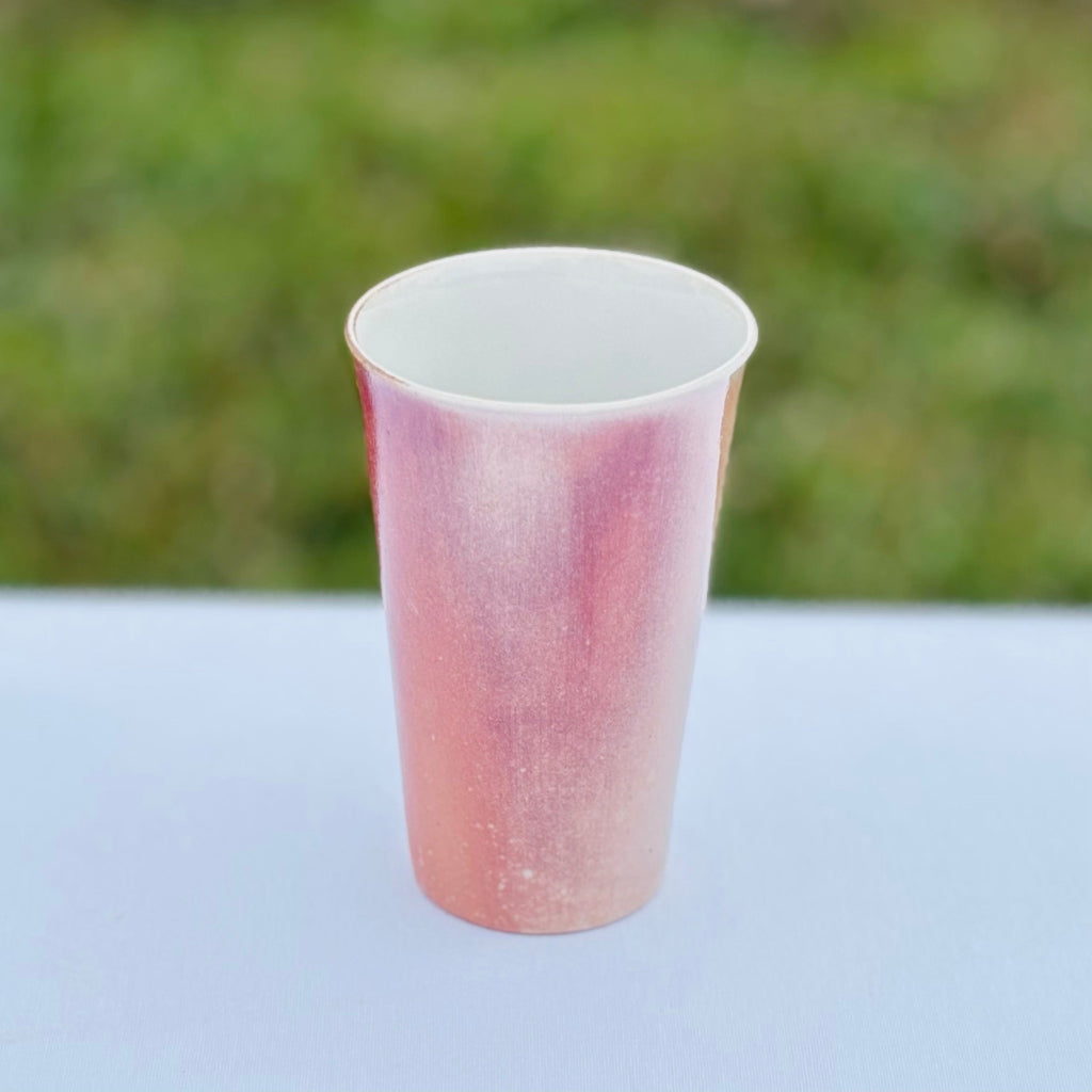 Artist made wood-fired porcelain cup by unglazed exterior with soft blush hues 