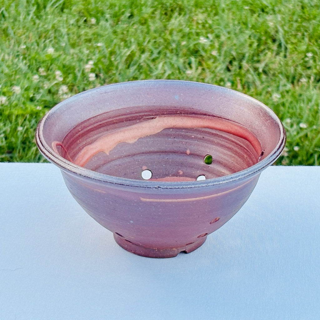 Interior view of ceramic berry bowl with white porcelain spiral design on natural fired clay surface 