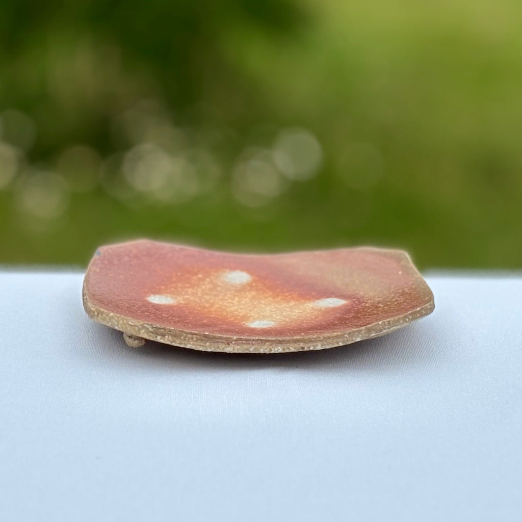 Functional porcelain soap dish with raised edges, a delicate round foot and artisan craftsmanship details